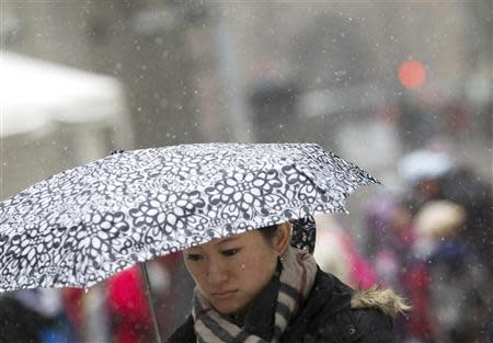 A woman walks through Times Square in New York January 21, 2014. REUTERS/Brendan McDermid