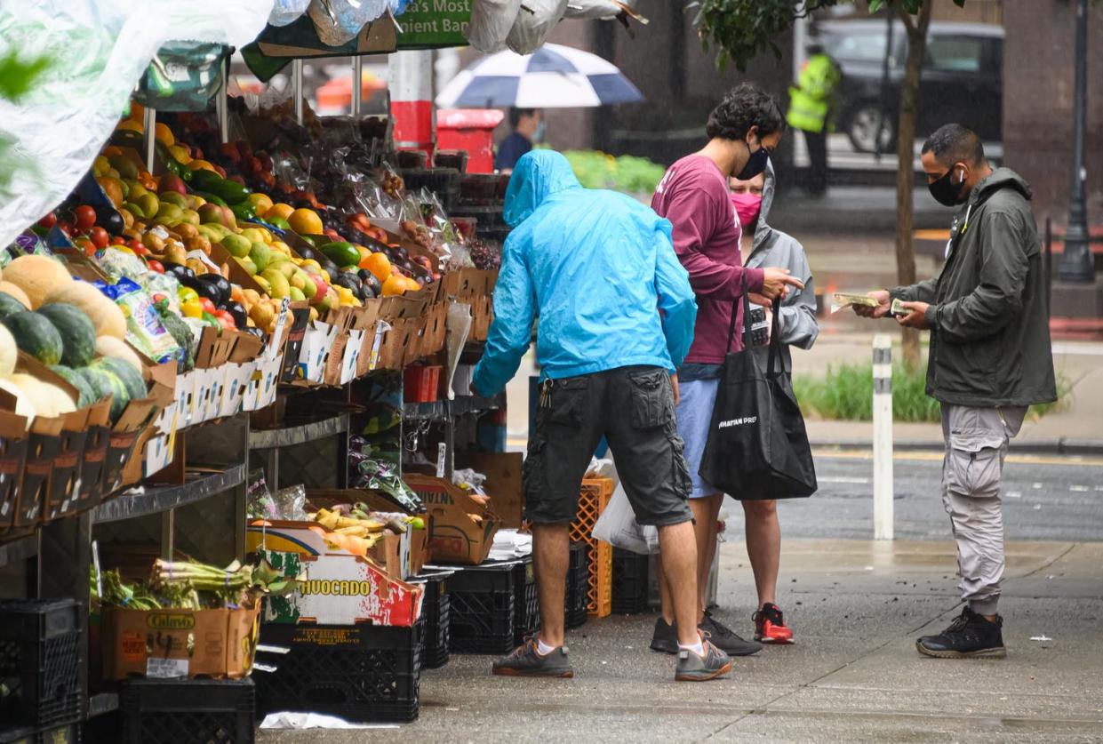 <span class="caption">People shop at a fruit and vegetable stand in Kips Bay, New York City, on July 10, 2020.</span> <span class="attribution"><a class="link " href="https://www.gettyimages.com/detail/news-photo/people-shop-at-a-fruit-and-vegetable-stand-in-kips-bay-as-news-photo/1255526466?adppopup=true" rel="nofollow noopener" target="_blank" data-ylk="slk:Noam Galai/Getty Images;elm:context_link;itc:0;sec:content-canvas">Noam Galai/Getty Images</a></span>