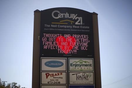 A Century 21 branch sign offers support to the families of the Umpqua Community College shooting victims in Roseburg, Oregon, United States, October 2, 2015. REUTERS/Lucy Nicholson