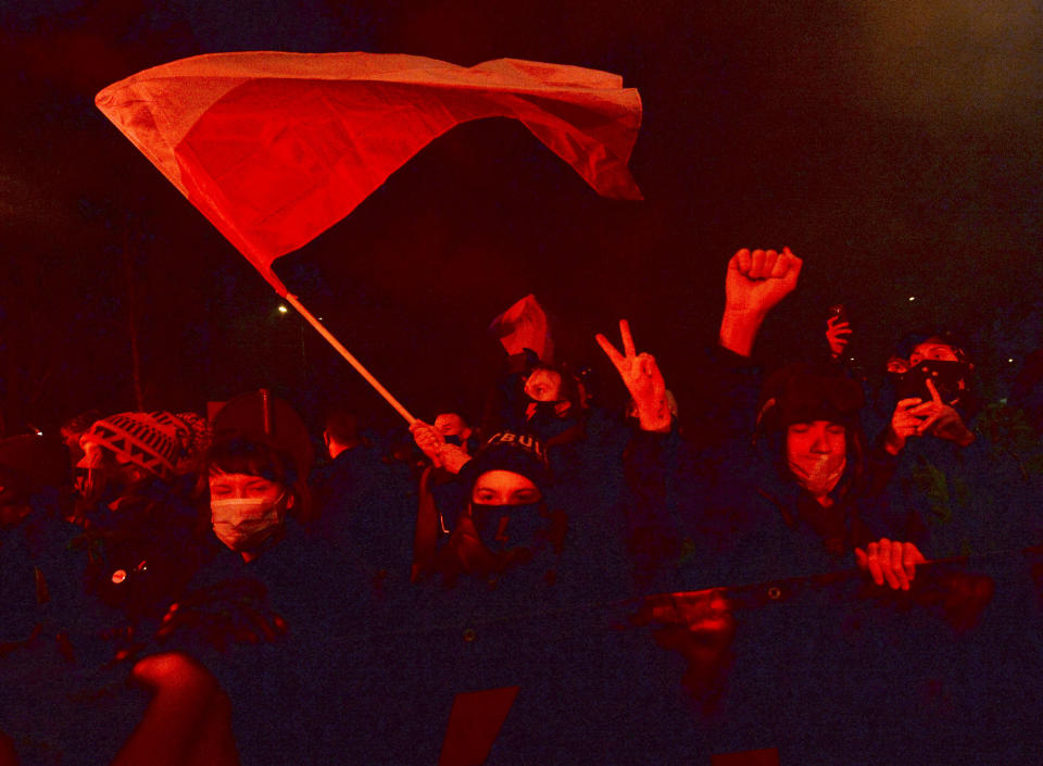 People protest against new anti-abortion laws, near the ruling Law and Justice party headquarters in Warsaw, Poland Wednesday Jan. 27, 2021, to protest after the country's top court on Wednesday confirmed its highly divisive ruling that will further tighten the predominantly Catholic nation's strict anti-abortion law. The Constitutional Tribunal published the justification of its decision, which will take immediate effect.(AP Photo/Czarek Sokolowski)