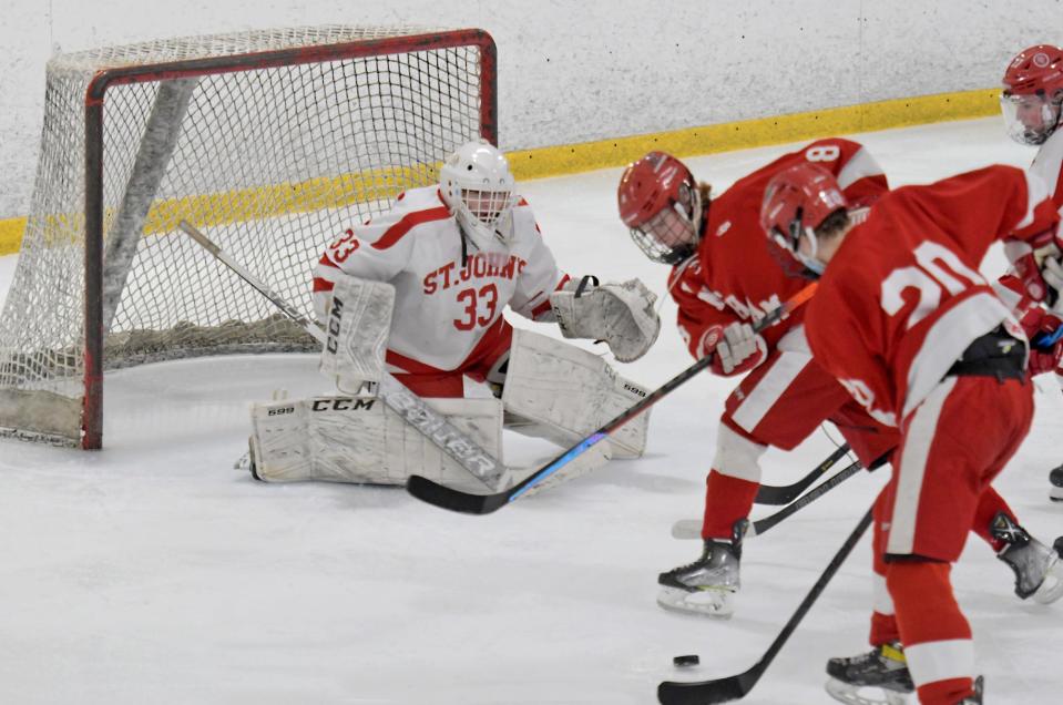 Hingham's Allu Linna, right, and Connoe Walsh close in on St. John's goalie Owen Polombo.