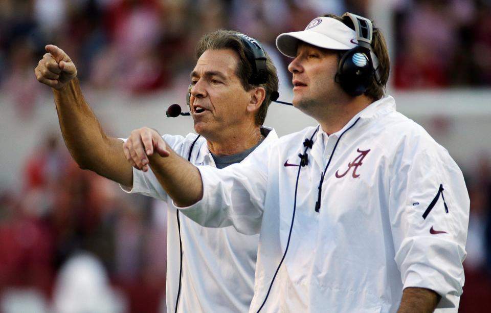 Alabama head coach Nick Saban, left, and then-defensive coordinator Kirby Smart call in a defense during the second half of an NCAA college football game against Tennessee, in Tuscaloosa, Alabama, on Oct. 26, 2013.