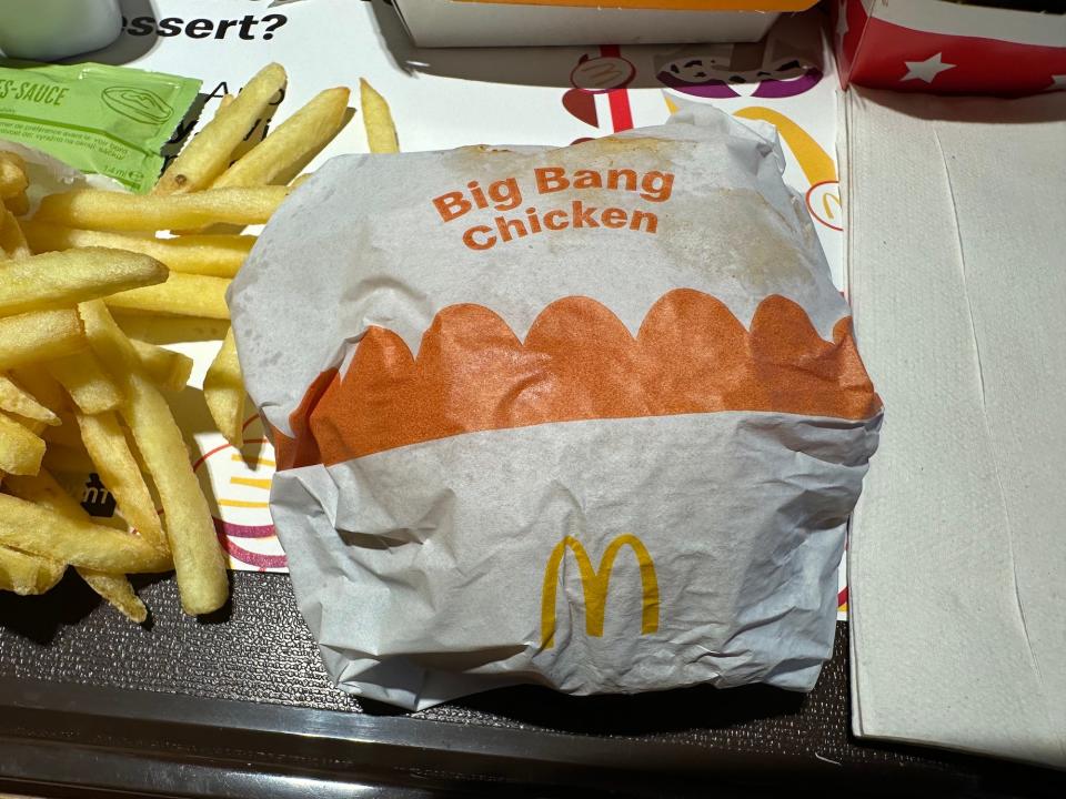 mcdonalds packaged big bang chicken sandwich on a tray next to french fries