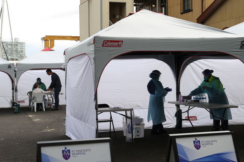 Medical workers and members of the public are seen at a COVID-19 pop-up testing centre in Sydney