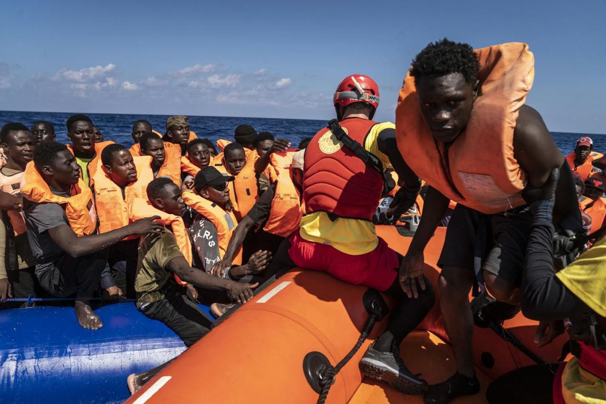 Workers from the Spanish nonprofit Open Waters rescue 178 migrants from different countries, off the coast of Italy in September 2023. <a href="https://www.gettyimages.com/detail/news-photo/migrants-of-different-14-nationalities-are-rescued-by-the-news-photo/1698787922?adppopup=true" rel="nofollow noopener" target="_blank" data-ylk="slk:Jose Colon/Anadolu Agency via Getty Images;elm:context_link;itc:0;sec:content-canvas" class="link ">Jose Colon/Anadolu Agency via Getty Images</a>