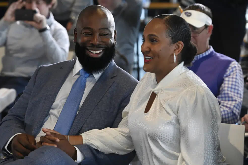 Ran Carthon, new Tennessee Titans NFL football team general manger, laughs with his wife Heaven as they both listen to head coach Mike Vrabel speak during a news conference Friday, Jan. 20, 2023, in Nashville, Tenn. (AP Photo/Mark Zaleski)