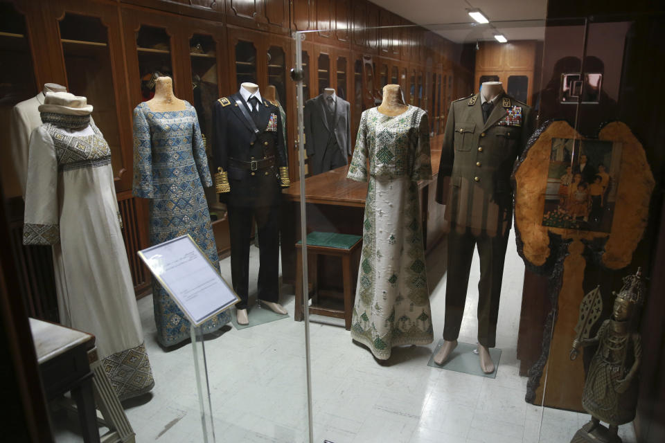 In this Tuesday, Jan. 15, 2019 photo, clothes that belonged to the late Shah Mohammad Reza Pahlavi and then Empress Farah Pahlavi are displayed at Niavaran Palace, now a museum, that was the primary and last residence of late Shah Mohammad Reza Pahlavi and his family prior to leaving Iran for exile during the 1979 Islamic Revolution, in northern Tehran, Iran. The palace complex of mansions on a 27-acre plot, nestled against the Alborz Mountains, now welcomes the public to marvel at the luxuries the shah enjoyed as Iran's monarch for nearly four decades. It costs about $1 to enter. (AP Photo/Vahid Salemi)