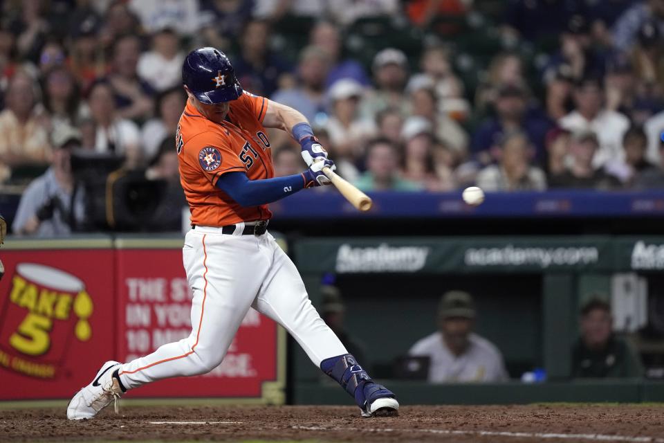 Houston Astros' Alex Bregman hits an RBI single against the Oakland Athletics during the eighth inning of a baseball game Friday, May 19, 2023, in Houston. (AP Photo/David J. Phillip)