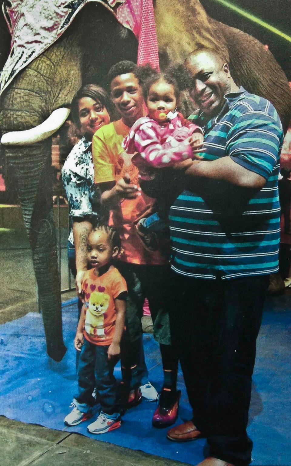 Eric Garner, right, poses with his children during a family outing - Family photo via National Action Network