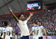England's Jude Bellingham celebrates after scoring his side's opening goal during the World Cup group B soccer match between England and Iran at the Khalifa International Stadium in Doha, Qatar, Monday, Nov. 21, 2022. (AP Photo/Alessandra Tarantino)