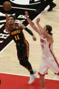 Atlanta Hawks guard Trae Young (11) shoots as Houston Rockets forward Kelly Olynyk (41) rushes in to try to block during the first half of an NBA basketball game on Sunday, May 16, 2021, in Atlanta. (AP Photo/Ben Gray)