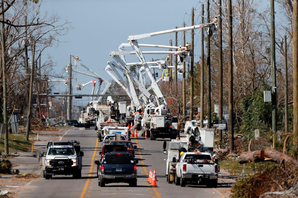 Utility crews set up new poles and utility wires in the aftermath of Hurricane Michael in Panama City, Fla., on Oct. 18, 2018.