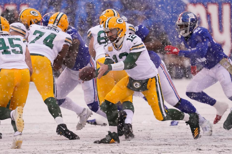 Dec 1, 2019; East Rutherford, NJ, USA; Green Bay Packers quarterback Aaron Rodgers (12) on a pitch in the snow against the Giants at MetLife Stadium. Mandatory Credit: Robert Deutsch-USA TODAY Sports