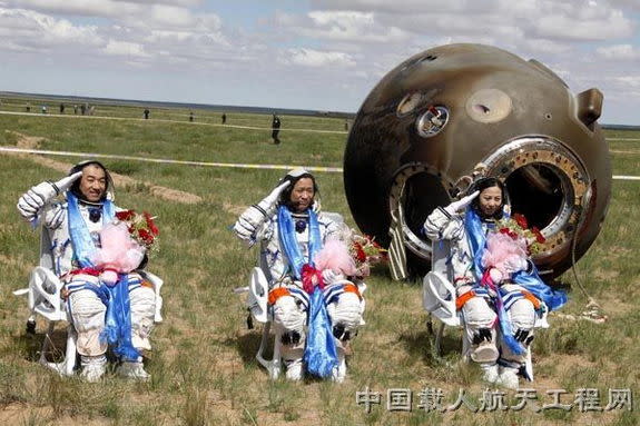 The crew of Shenzhou 10, China's fifth human spaceflight mission, salutes after a safe landing in inner Mongolia on the morning of June 26 local time in 2013. The crew is, from left: Zhang Xiaoguang, Shenzhou 10 commander Nie Haisheng and Wang