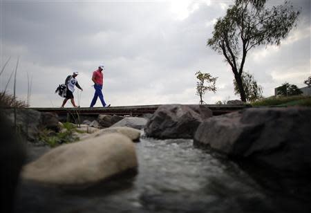 Luke Guthrie of U.S. walks to the ninth hole during the BMW Masters 2013 golf tournament at Lake Malaren Golf Club in Shanghai October 25, 2013. REUTERS/Carlos Barria