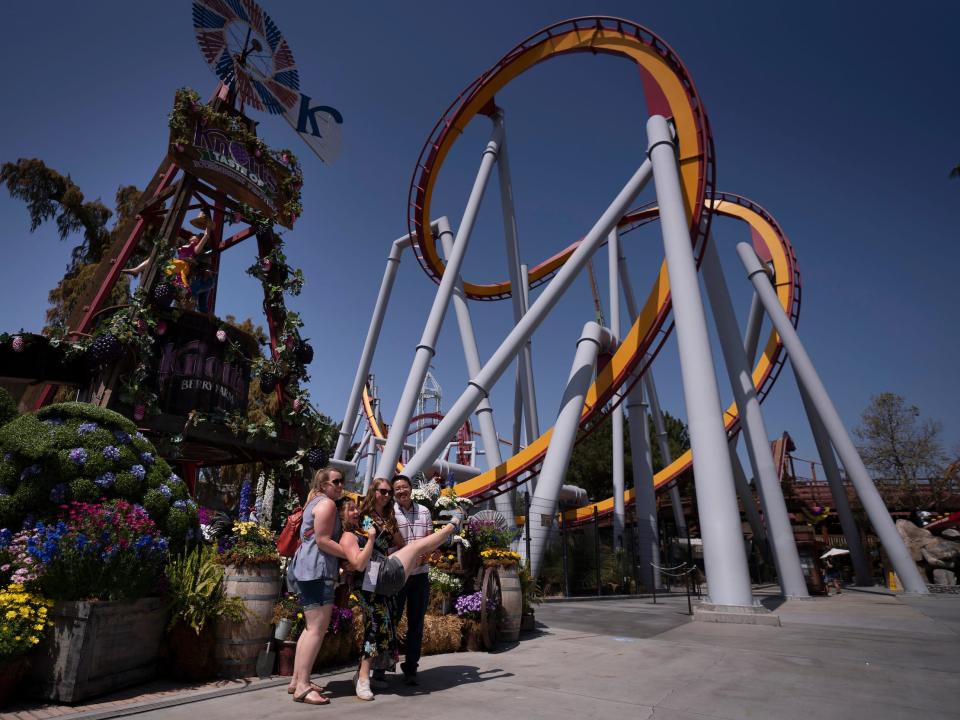 Group poses for photo in front of roller coaster at Knott's Berry Farm