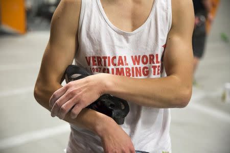 Drew Ruana, 16, a competitive climbing national champion, holds his climbing shoes as he trains at Stone Gardens rock climbing gym in Bellevue, Washington October 20, 2015. REUTERS/Jason Redmond