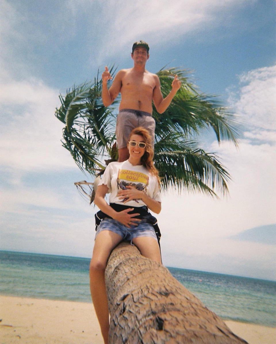 Demi Harman and Andrew Brooks on a palm tree in Queensland