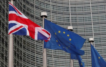 FILE PHOTO: A Britain's and some European flags are hung outside the EU Commission headquarters in Brussels, Belgium December 4, 2017.  REUTERS/Yves Herman