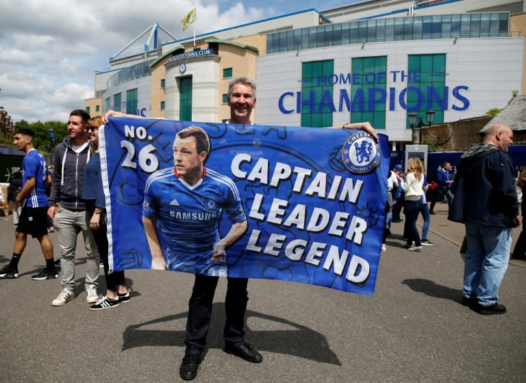 A fan holds out a flag in support of captain John Terry outside of Stamford Bridge in London on May 21, 2017