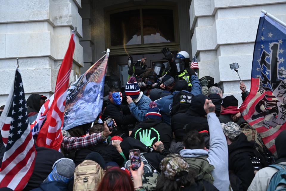 TOPSHOT - Trump supporters clash with police and security forces as they storm the US Capitol in Washington, DC on January 6, 2021. - Thousands of Trump supporters, fueled by his spurious claims of voter fraud, flooded the nation's capital protesting the expected certification of Joe Biden's White House victory by the US Congress. (Photo by Brendan SMIALOWSKI / AFP) (Photo by BRENDAN SMIALOWSKI/AFP via Getty Images)