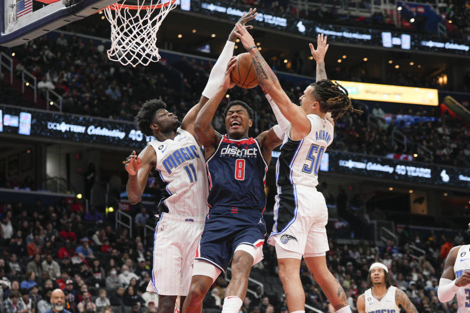 Washington Wizards forward Rui Hachimura (8) goes up against Orlando Magic center Mo Bamba (11) and guard Cole Anthony (50) during the first half of an NBA basketball game, Saturday, Jan. 21, 2023, in Washington. (AP Photo/Jess Rapfogel)