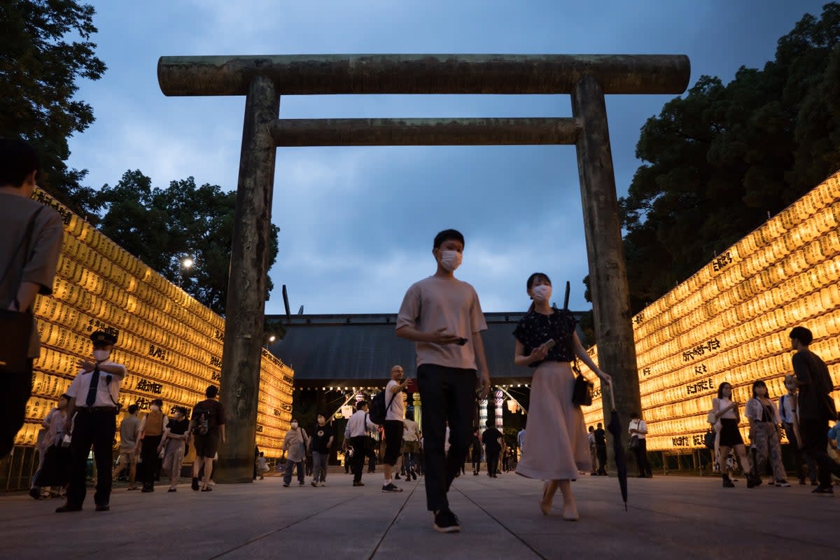 File: People walk past lit paper lanterns during the Mitama Matsuri summer festival at the Yasukuni Shrine  (Getty Images)