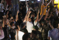 Anti-government protesters shout slogans during a protest against the political leadership they blame for the economic and financial crisis, in front the government house, in downtown Beirut, Lebanon, Thursday, June 11, 2020. Hundreds of Lebanese poured into the streets to protest the tumbling of the national currency to a new low against the dollar on Thursday, blocking roads and highways in several places across the small country that had started slowly opening up after coronavirus restrictions. (AP Photo/Hussein Malla)