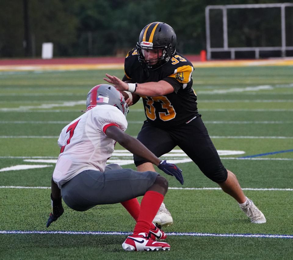 Nanuet's Evan Moran (33) works to break a tackle during their 29-0 win over Sleepy Hollow in football action at Nanuet High School on Saturday, September 9, 2023.