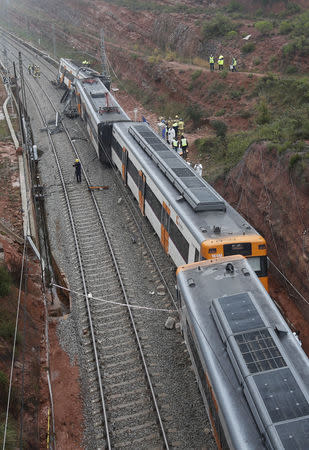 Rescue workers survey the scene after a commuter train derailed between Terrassa and Manresa, outside Barcelona, Spain, November 20, 2018. REUTERS/Albert Gea