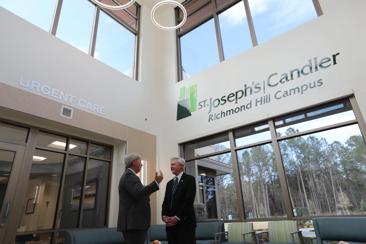 Paul Hinchey, president and CEO St. Joseph's/Candler, (right) talks with Steve Sellars, CEO Premier Health Urgent Care, in the lobby of the new St. Joseph's/Candler Richmond Hill campus during the grand opening ceremony Feb. 23.