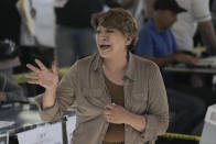 Delfina Gomez, Mexico state gubernatorial candidate for the National Regeneration Movement, or MORENA, waves after she cast her vote at a polling station in Texcoco, Mexico state, Sunday, June 4, 2023. (AP Photo/Eduardo Verdugo)