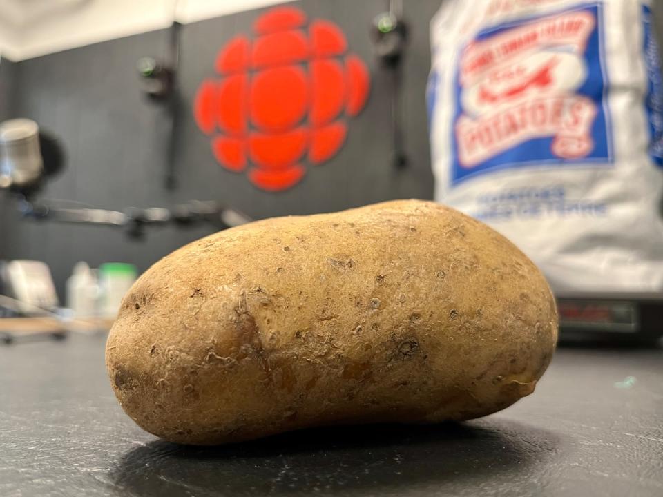Various pictures of PEI potaoes, including the typical potatoe bag. See also potato bag and potatoes in a cbc studio.