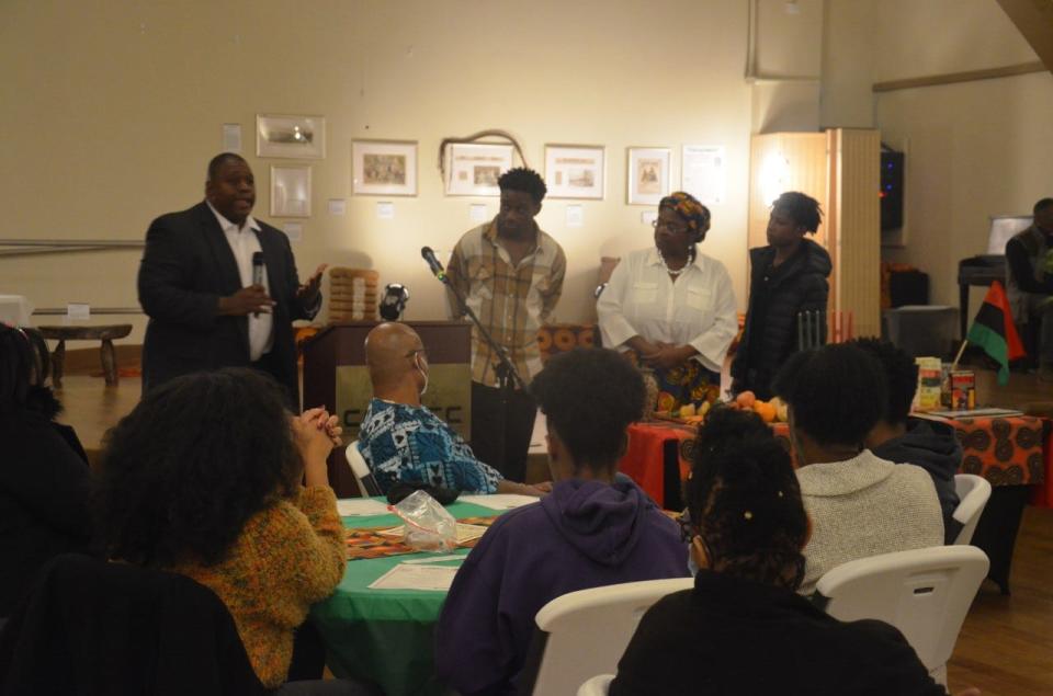 Attorney Aubroncee Martin, left, and his family explain the meaning of Umoja (Unity) and lit the first candle during a Kwanzaa ceremony held on Dec. 26 at the Cotton Club Museum and Cultural Center in southeast Gainesville.
(Photo: Photo courtesy of Clayton Photography/Special to The Guardian)