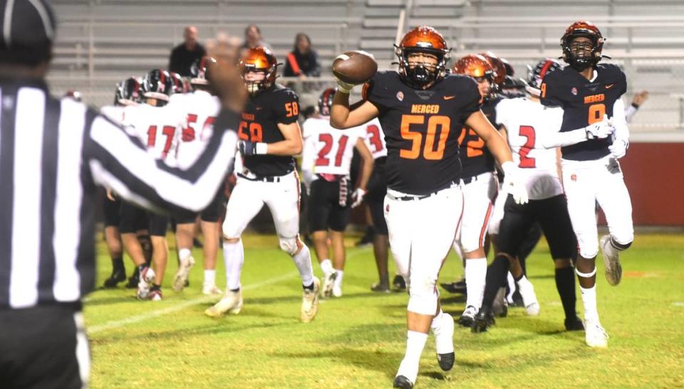 Merced High School senior defensive lineman Andre Pulliam (50) recovers a fumble during the first quarter against Bella Vista on Friday, Nov. 3, 2023.