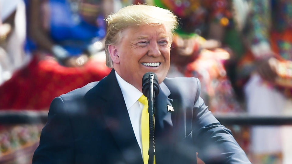 US President Donald Trump smiles talking.