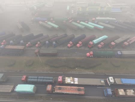 Trucks are seen stranded near a highway during a polluted day in Shijiazhuang, Hebei province, China December 20, 2016. REUTERS/Stringer