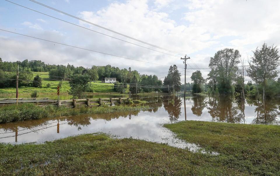 A bridge on Trunk 14 in Newport, N.S., is seen completey submerged in water on Saturday.