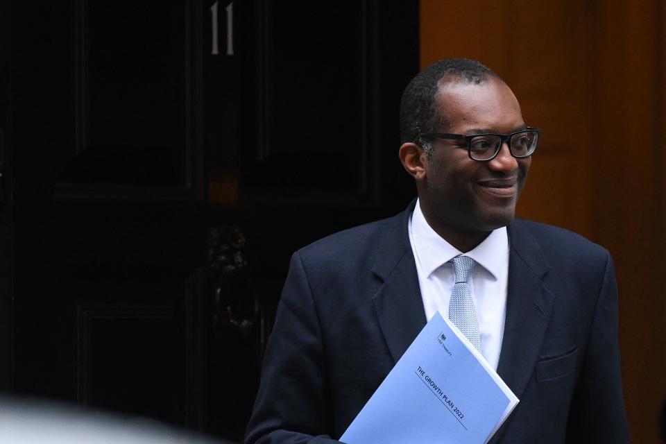 FTSE 100 Britain's Chancellor of the Exchequer Kwasi Kwarteng holds a folder reading 