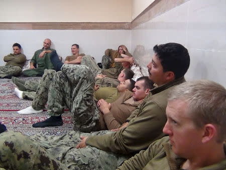 An undated picture released by Iran's Revolutionary Guards website shows American sailors sitting in an unknown place in Iran. REUTERS/sepahnews.ir/TIMA/Handout via Reuters