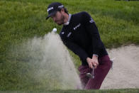 Sam Ryder hits out of a bunker on the 18th hole of the South Course at Torrey Pines during the final round of the Farmers Insurance Open golf tournament, Saturday, Jan. 28, 2023, in San Diego. (AP Photo/Gregory Bull)