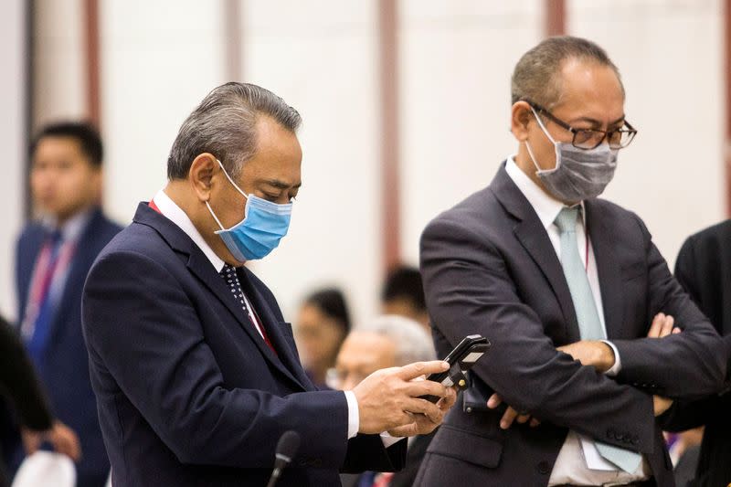Delegates wearing protective mask attend the Foreign Ministers of the ASEAN and China emergency meeting on the coronavirus in Vientiane, Laos