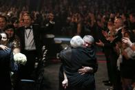 ADDITIONAL WEDDING DETAILS INCLUDED - Audience members participate in a same sex wedding during a performance of "Same Love" by Macklemore and Ryan Lewis at the 56th annual Grammy Awards at Staples Center on Sunday, Jan. 26, 2014, in Los Angeles. With Queen Latifah presiding from the stage and the music playing, 33 straight and gay couples lined the aisle dressed in wedding finery. Under Latifah's command, they exchanged rings near the end of Sunday night's show televised on CBS. (Photo by Matt Sayles/Invision/AP)