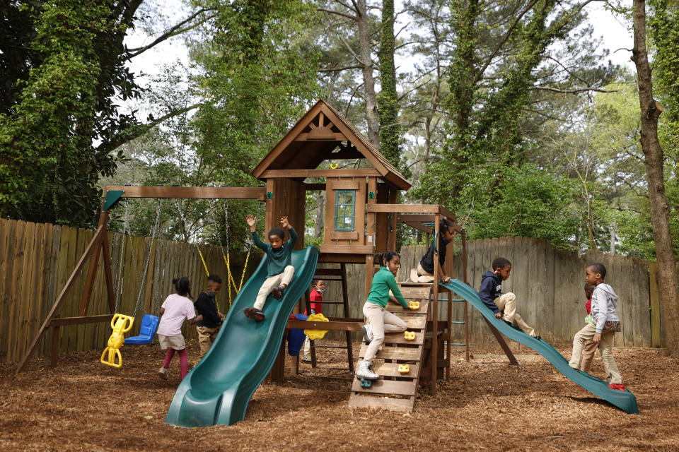 Students play on the playground at the Kilombo Academic and Cultural Institute, Tuesday, March 28, 2023, in Decatur, Ga. (AP Photo/Alex Slitz)