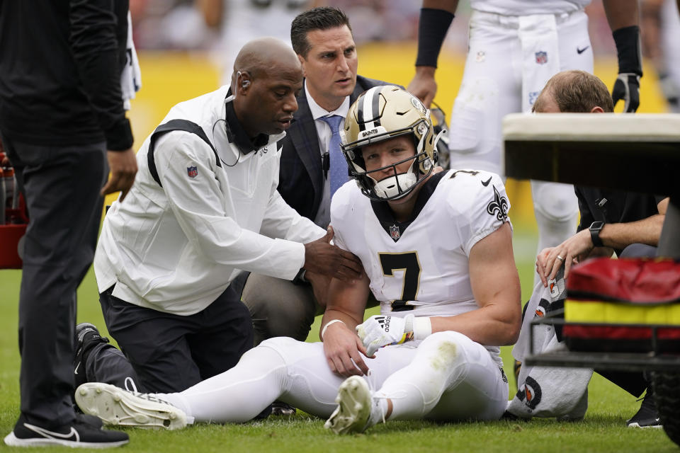 New Orleans Saints wide receiver Taysom Hill is tended to after being injured in the first half of an NFL football game against the Washington Football Team, Sunday, Oct. 10, 2021, in Landover, Md. (AP Photo/Alex Brandon)