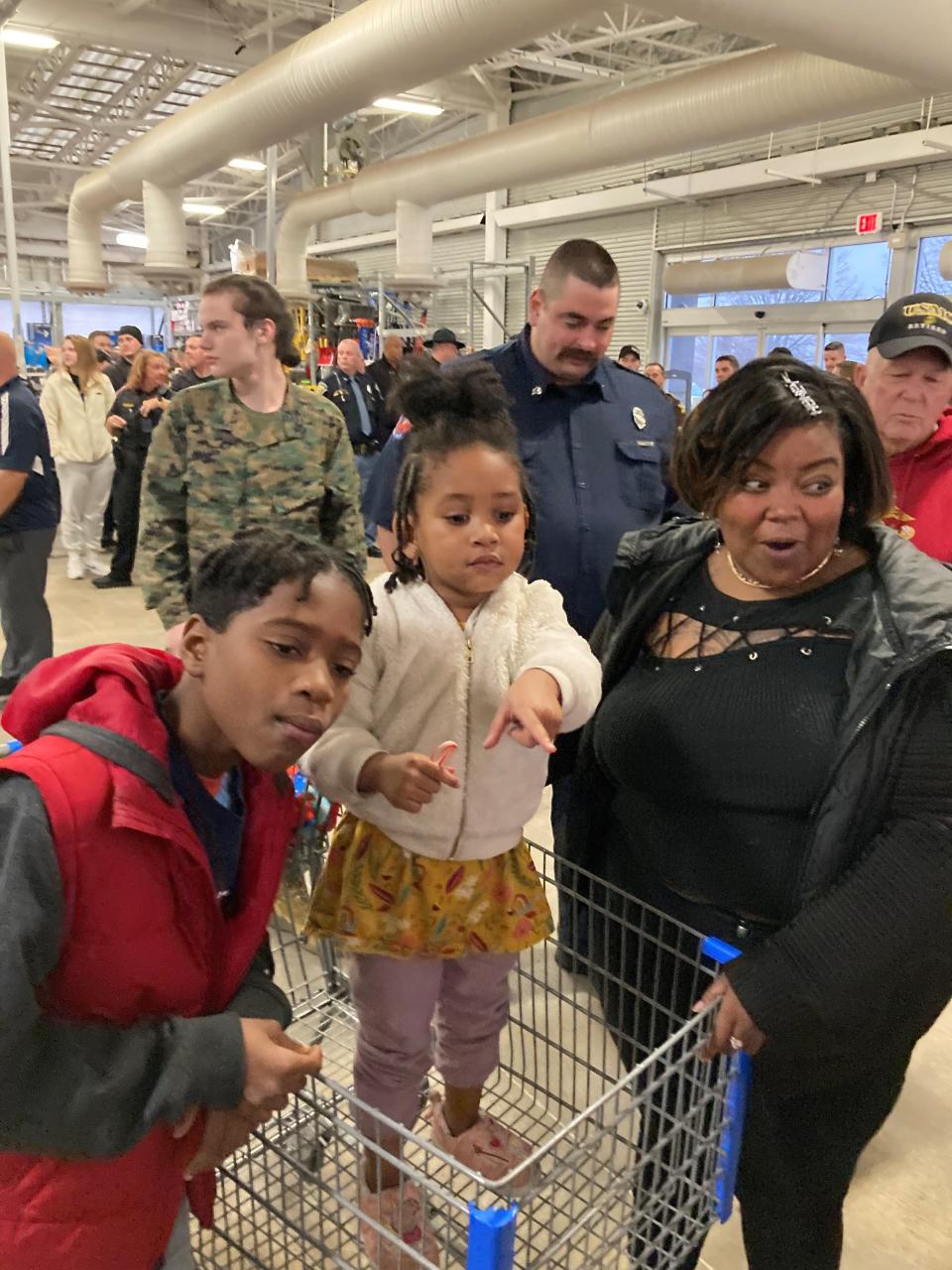 Travis Thomas, Ronii Thomas and  Ty Durben survey the scene at Walmart South prior to going on a Christmas shopping spree Saturday .