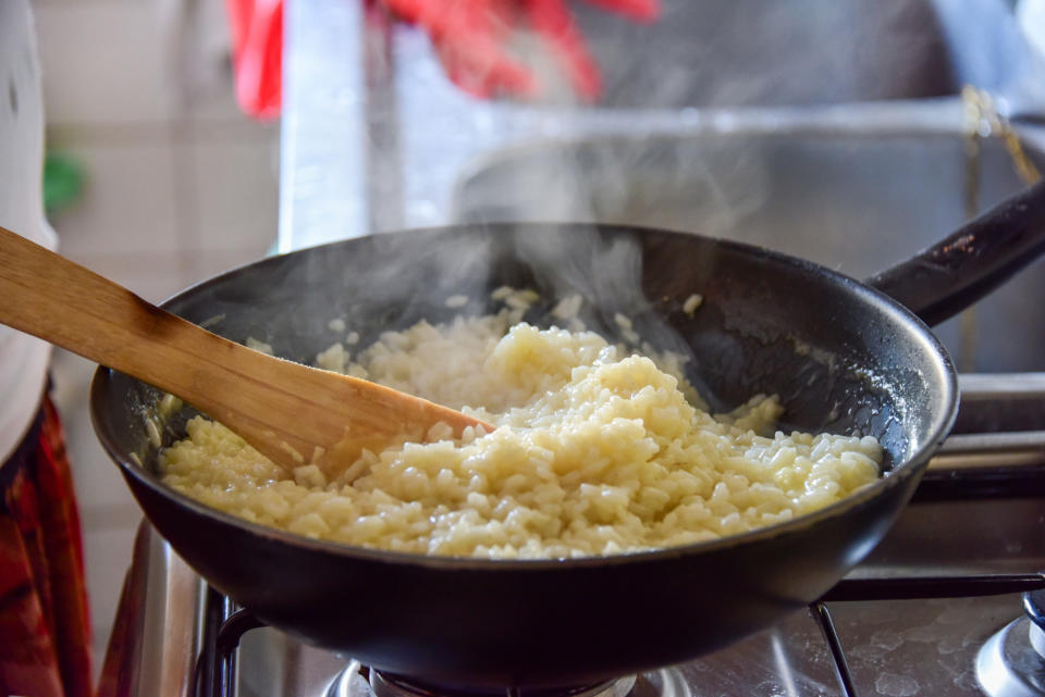 Stirring risotto in a skillet.