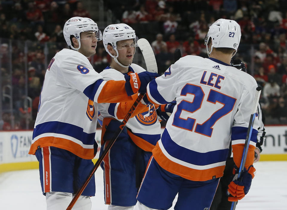 New York Islanders right wing Oliver Wahlstrom, center, celebrates his goal against the Detroit Red Wings with defenseman Noah Dobson (8), and left wing Anders Lee (27) during the second period of an NHL hockey game Saturday, Dec. 4, 2021, in Detroit. (AP Photo/Duane Burleson)