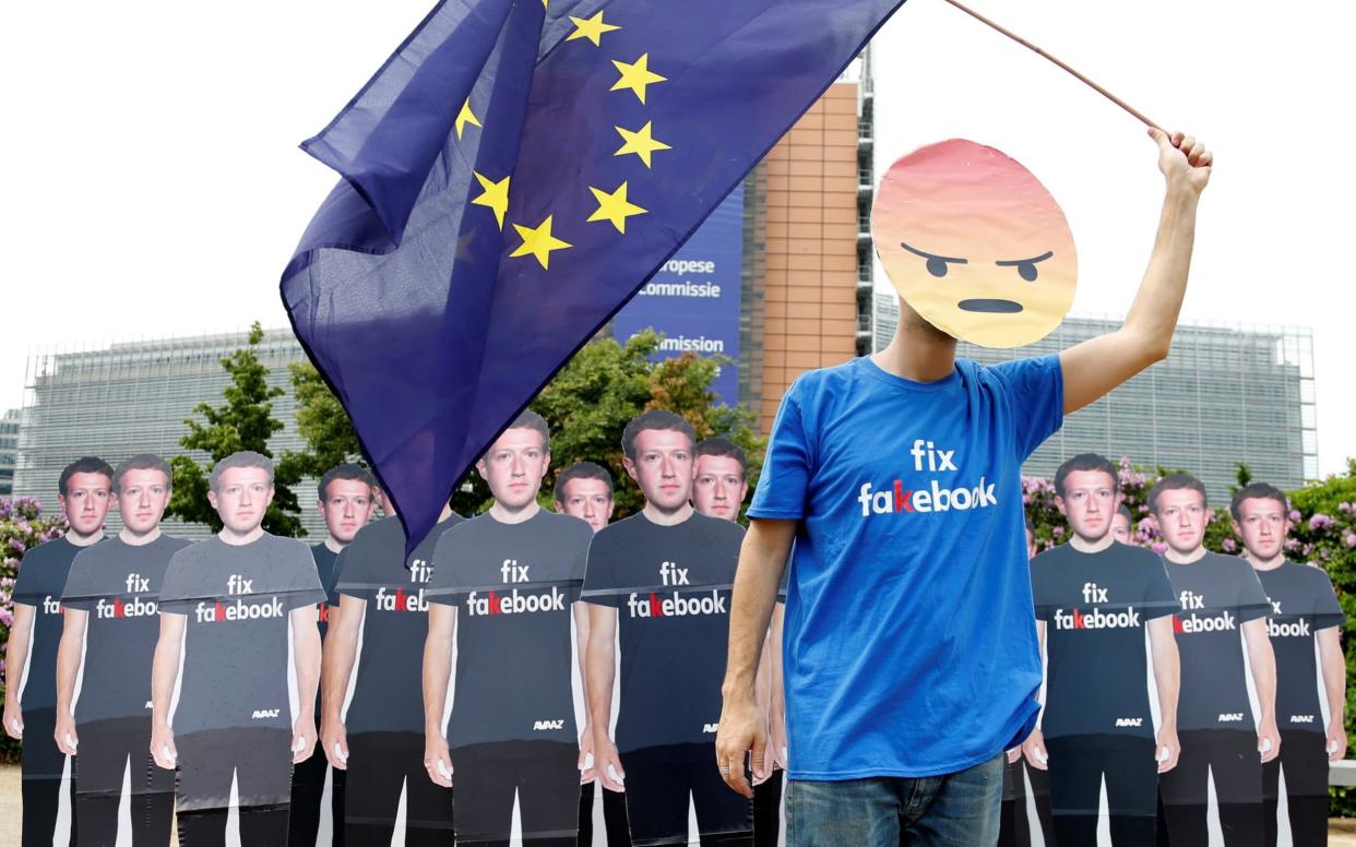 Protestors outside the European Commission in Brussels, as Facebook CEO Mark Zuckerberg met with leading MEPs to explain the data breach at the company. - REUTERS