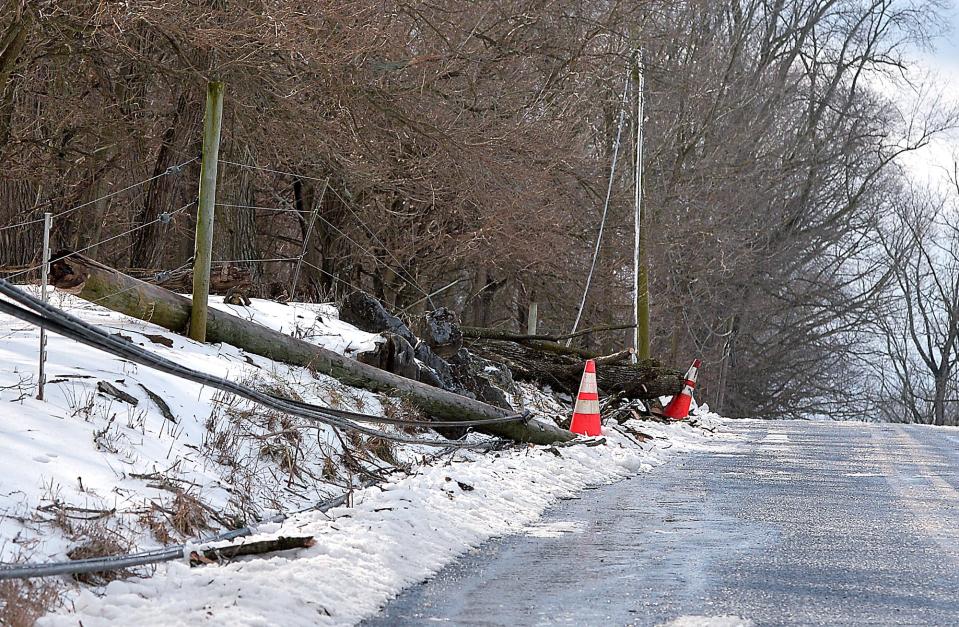 A downed tree and power line is cleared from Beard Spur Road between Old Forge Road and Route 62 west of Smithsburg after a winter storm moved through the area Sunday into Monday.